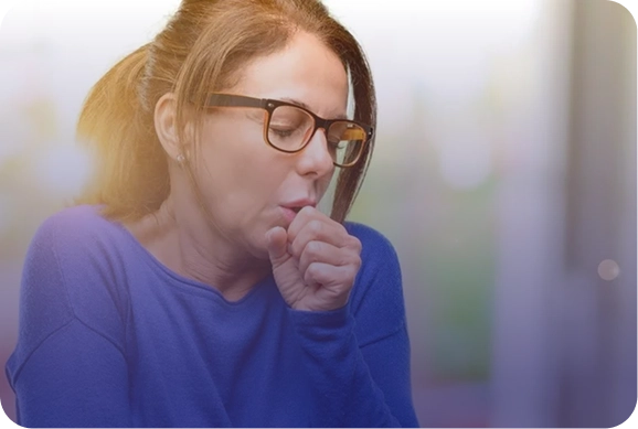 Woman coughing and holding her chest indicating difficulty in breathing Woman coughing and holding her chest, indicating difficulty in breathing